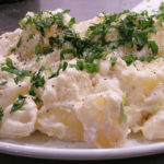 warm potato salad with soft cheese and scallion